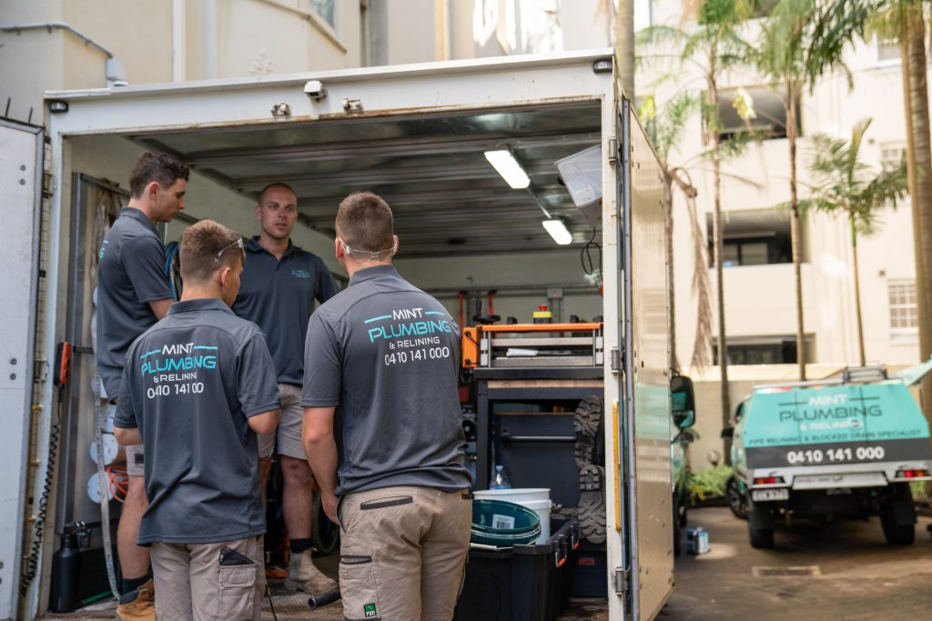 Members of the Mint Plumbing team Discussing a job