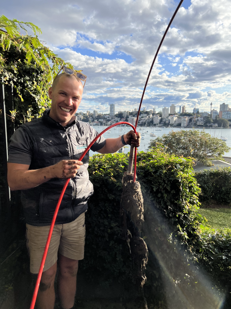 Professional plumber clearing a severe drain blockage using jetting equipment in Sydney’s Eastern Suburbs.