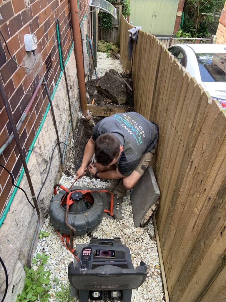 One of the Mint Plumbing and Relining team using a Camera