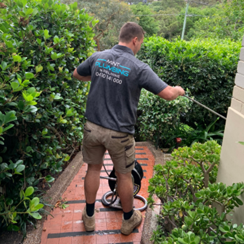 A plumber attending to a blocked drain